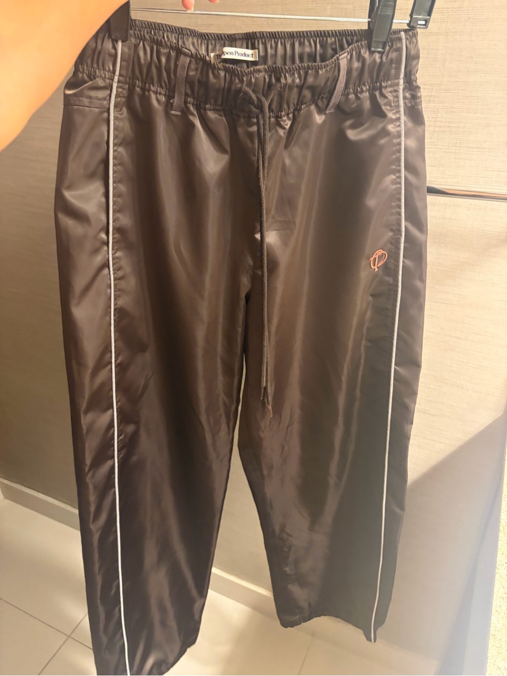 The open product brown Track Joggers with White Piping